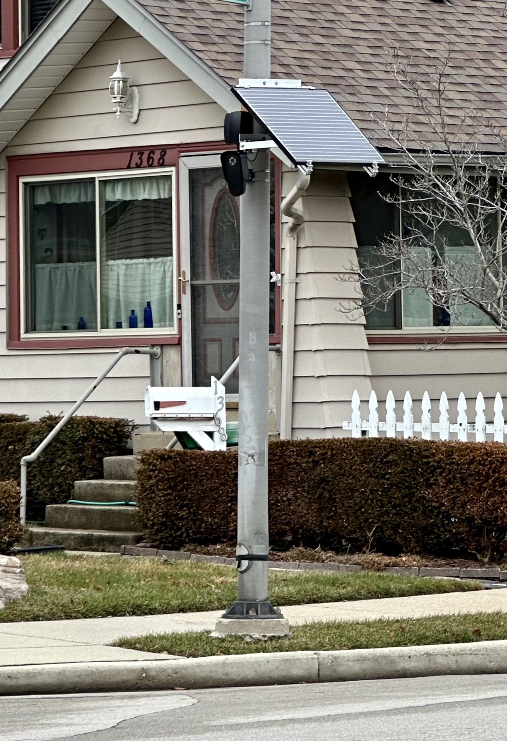 Flock Safety ALPR camera with solar panel mounted on a light pole